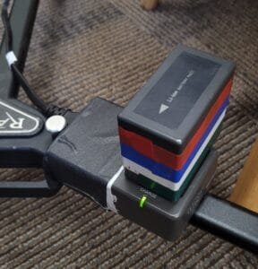 Camera power adapter charging a battery