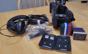 Camera, headset, 15ft XLR cable, lapel microphone, three 32GB SD cards, SD card case, and two batteries, as part of the kit